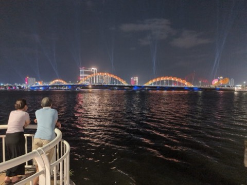 The Dragon Bridge lit up at night across the Han River in Da Nang