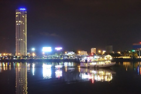 The Han River waterfront in Da Nang at night, with city lights reflected in the water