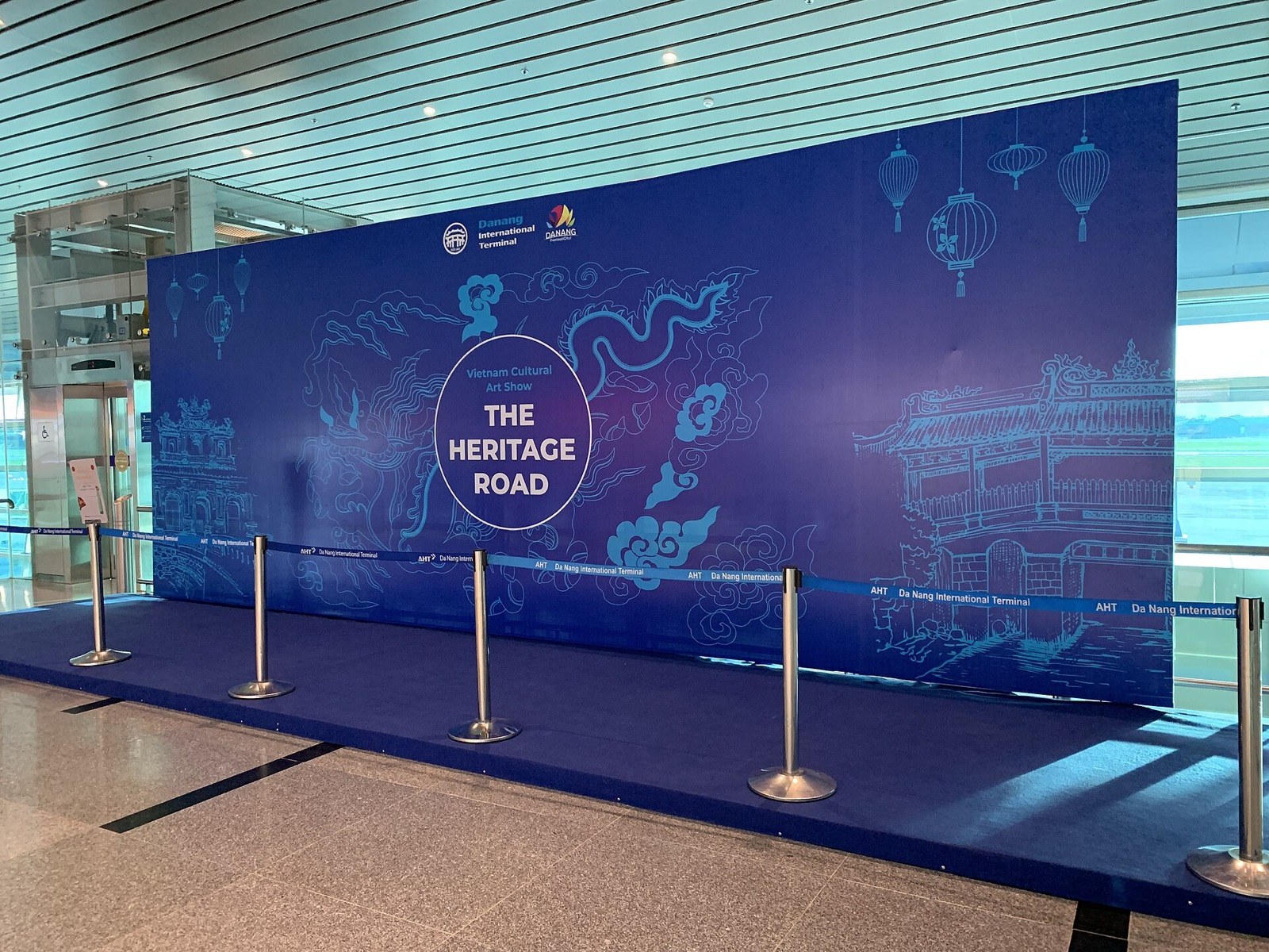 A blue exhibition wall titled The Heritage Road inside the international terminal at Da Nang airport