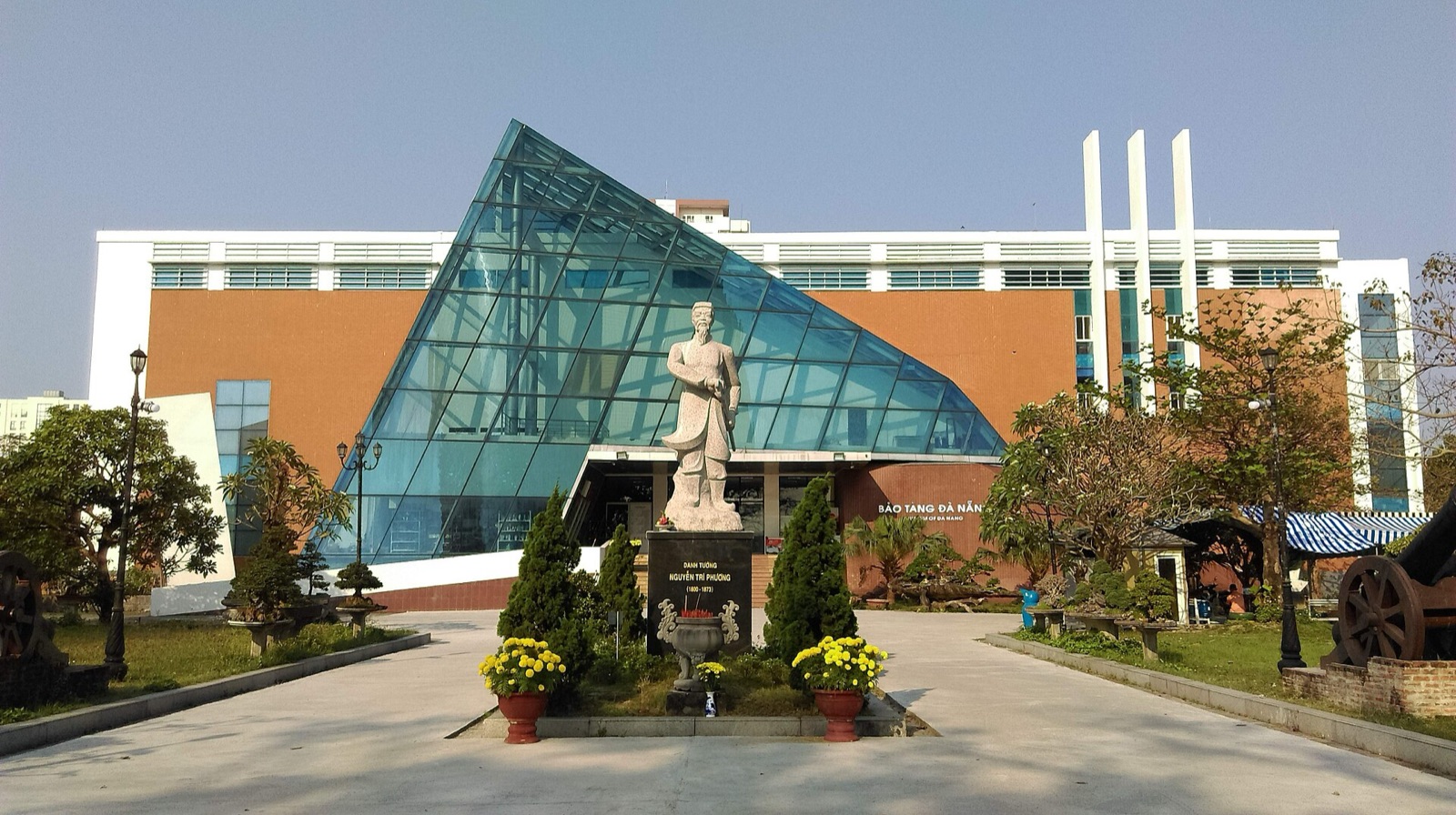 The front of the Da Nang Museum building with a glass pyramid entrance and landscaped forecourt