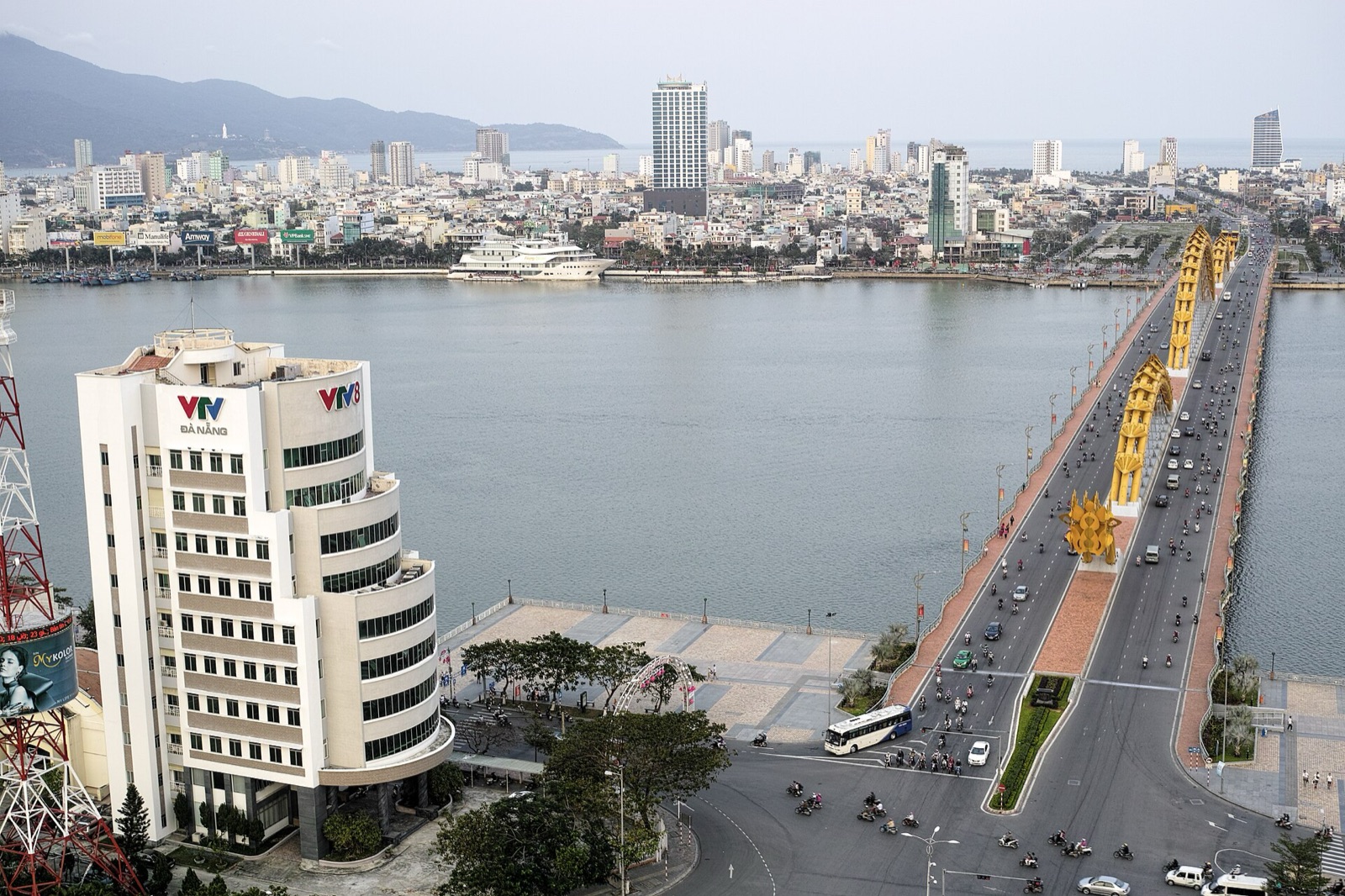 Elevated view of the Dragon Bridge across the Han River with traffic, high-rises and mountains beyond