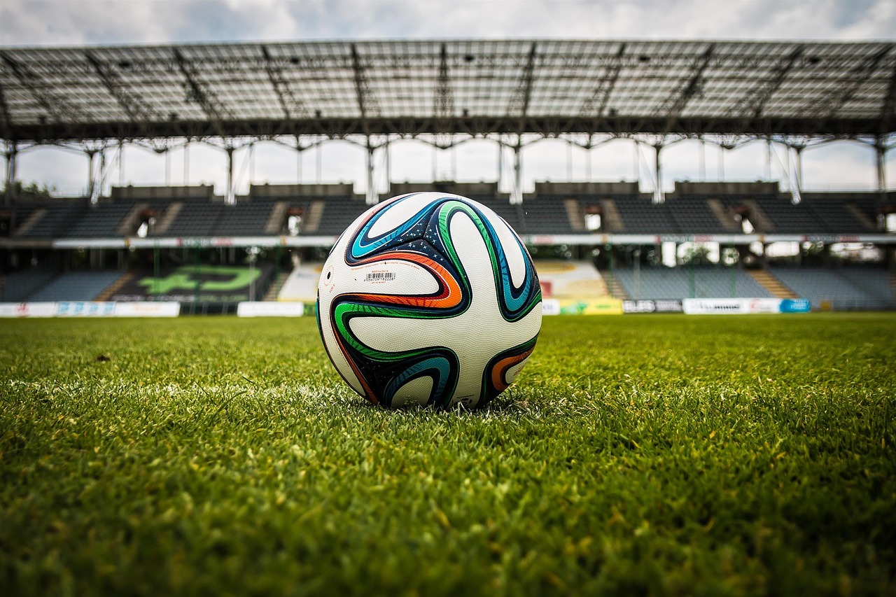 Stock photo of a football on a stadium pitch